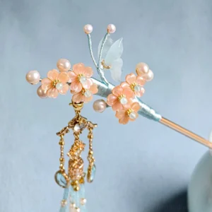 Close-up traditional Chinese floral tassel hair stick featuring a translucent light blue butterfly ornament, faux pearls, gold-tone pendant, and delicate Hanfu hair accessory details