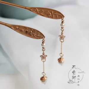 Traditional Chinese tassel hair stick with engraved floral ornament, pearl-like bead details, and sparkling zircon accents on white silk fabric