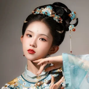 Side view of a traditional Chinese Hanfu hairstyle decorated with blue hairpins pearl accents red agate and flowing tassel ornaments