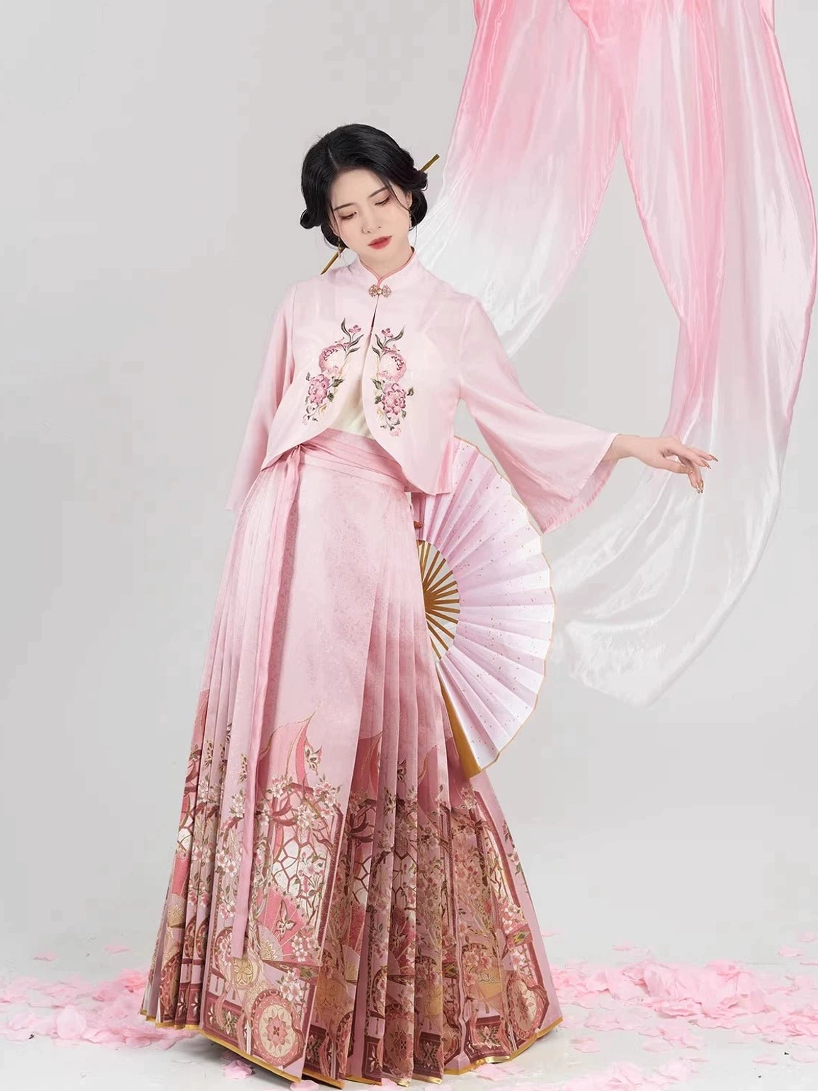 Side three-quarter view of a traditional Chinese hanfu set with stand-collar cropped blouse, flowing sleeves, and printed mamian skirt