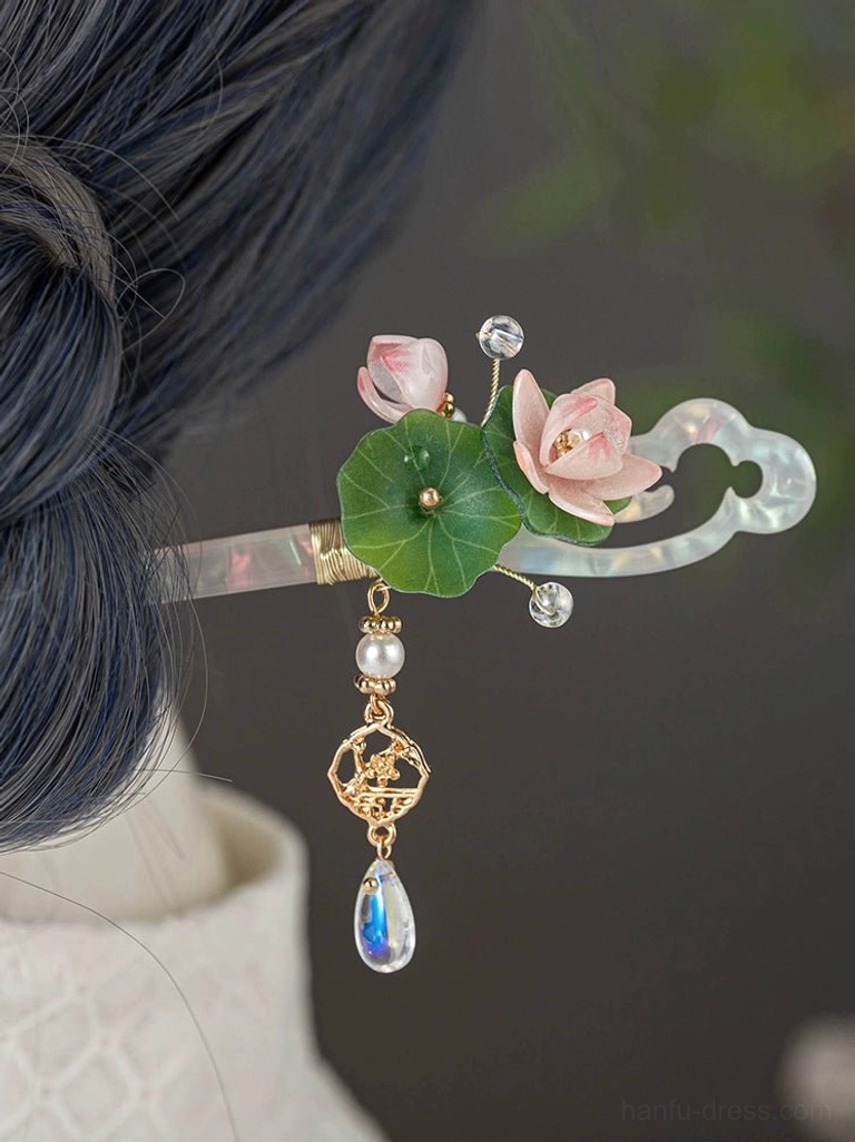 Traditional Chinese lotus hair stick secured in dark blue hair, showing the complete Hanfu hair accessory design with floral ornament and dangling charm