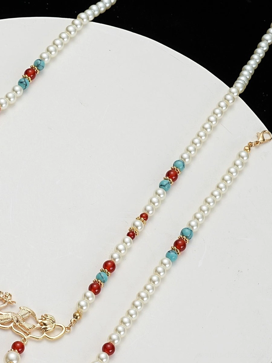 Close-up detail of a traditional Chinese necklace chain with pearl-style strands, red agate-style beads, turquoise accents, and gold-toned metal clasp