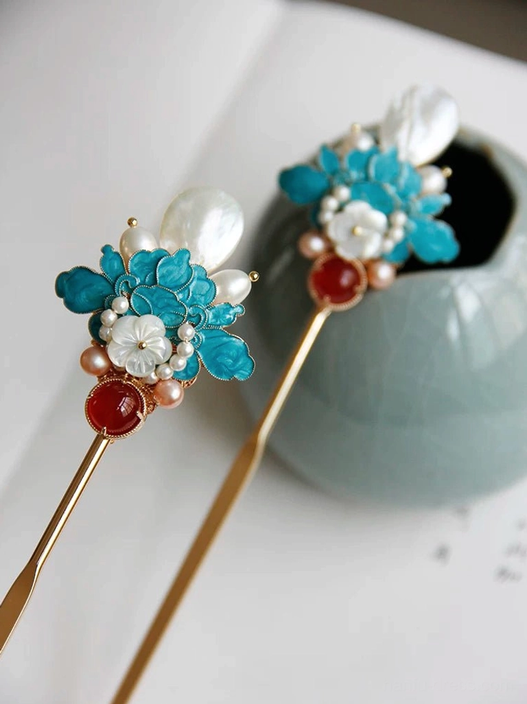 Traditional Chinese peony hairpin design with blue floral accents, white carved shell flowers, pearl details, and red agate-style ornaments