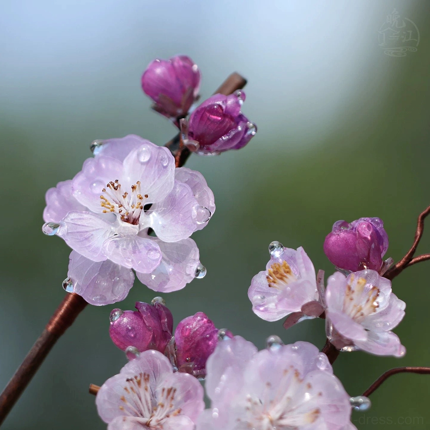 Front low-angle close-up of a traditional Chinese plum blossom hair pin with detailed flower centers and water-drop-inspired pink petals