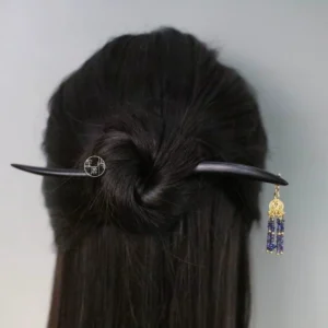 Traditional Chinese tassel hair accessory secured in long dark hair showing the elegant rear hairstyle and beaded ornament