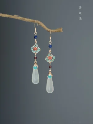 Traditional Chinese water drop earrings for Hanfu displayed on a dry twig against a dark gray background, with blue beads, red accents, white pendants, and Qing Feng Ji decorative text
