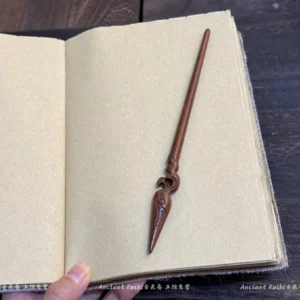Traditional Chinese wooden hair pin with carved swirl knot decoration and tapered spear tip shown from a three-quarter angle