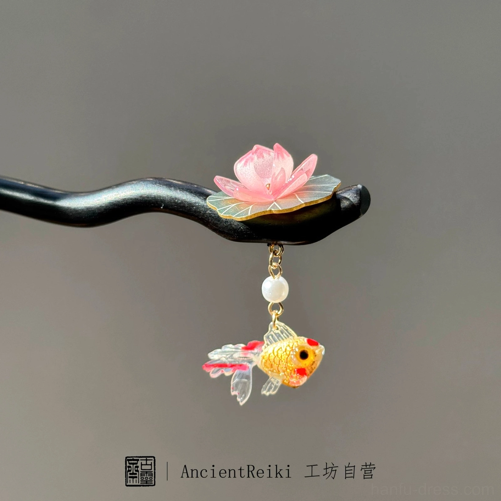 Traditional lotus and goldfish wooden hairpin with a pink flower, green leaf, white pearl, and golden fish pendant for Hanfu hairstyles