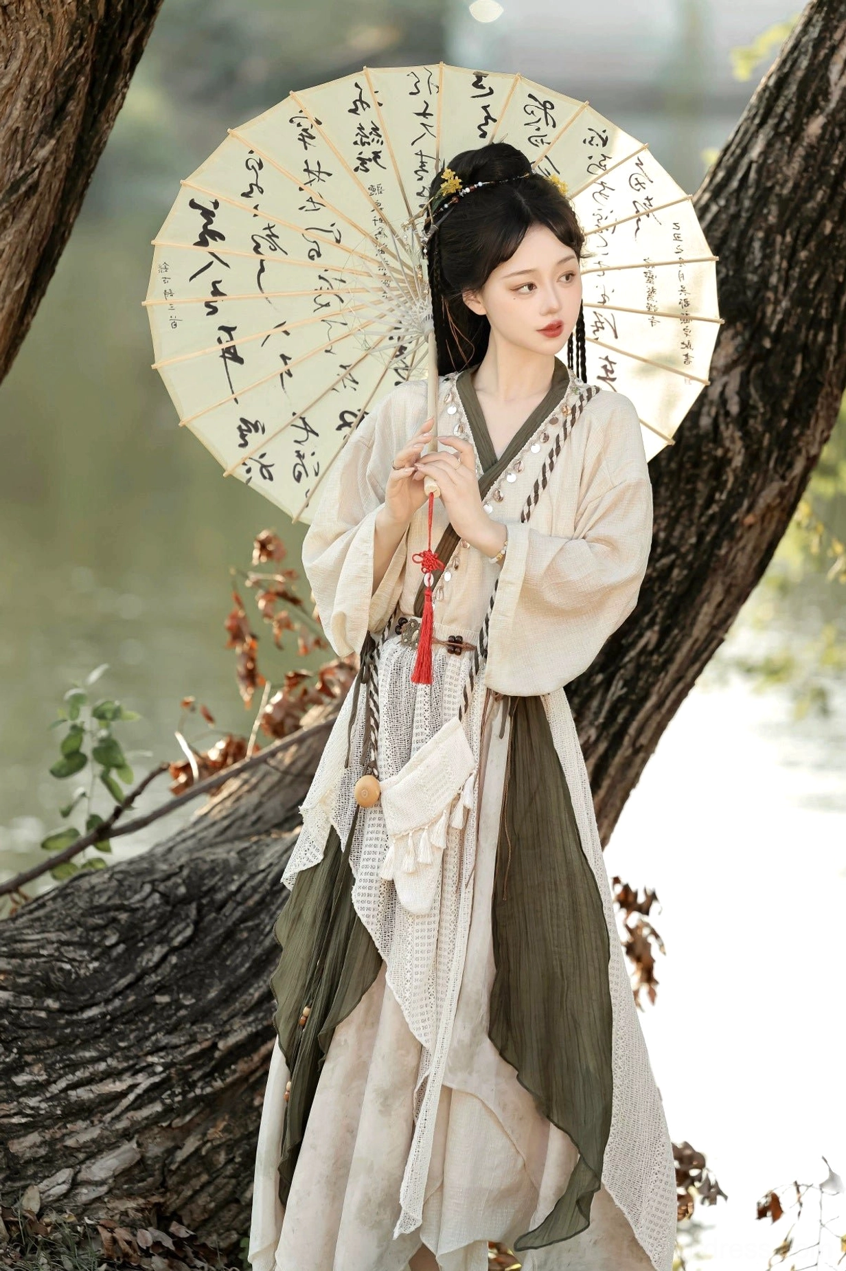 Close full-length view of Travelling Lotus modern Hanfu cross-collar top with olive green trim and flowing layered asymmetrical skirt