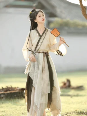 Three-quarter view of Travelling Lotus modern Hanfu outfit with layered asymmetrical skirt, cross V-neck top, and olive green waist accents