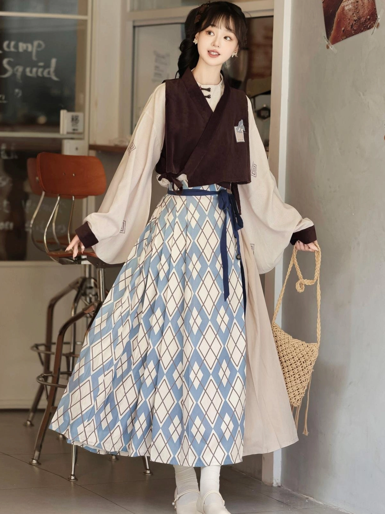 Side detail view of Travels in the Mountains modern Hanfu outfit showing embroidered sleeve cuff woven bag and color-block mamian skirt