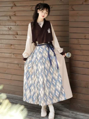 Back three-quarter view of women’s modern Ming Dynasty Hanfu outfit with brown vest blue geometric mamian skirt and beige top