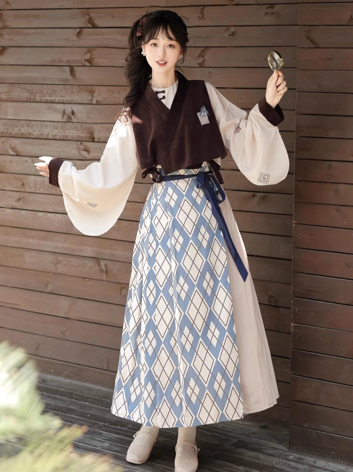 Side view of modern Ming Dynasty Hanfu three-piece set showing wide sleeves contrast cuffs cropped vest and wrap mamian skirt