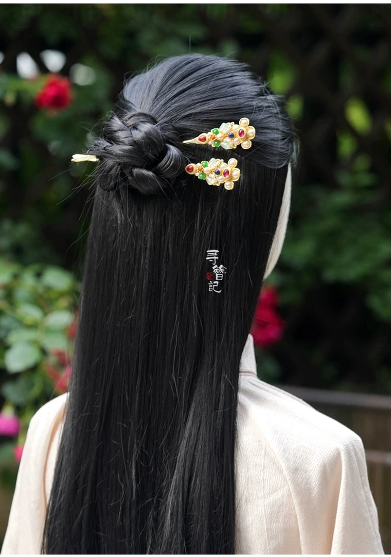 Treasure Wind Chinese Hanfu hairpin worn in a braided traditional updo with a light beige Hanfu outfit in an outdoor garden setting