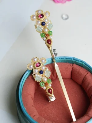 Treasure Wind Chinese Hanfu hairpin displayed on a red velvet jewelry box with gold-tone floral filigree, pearl-like beads, jade-like accents, and colorful gemstone-style details