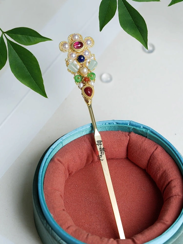 Side view of Treasure Wind long Chinese Hanfu hair stick with a gold-tone pin and ornate pearl, jade-like, and colorful floral ornament