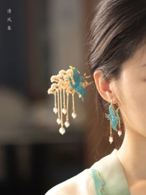 Model wearing turquoise cloisonne crane pearl tassel earrings with Hanfu and a matching traditional Chinese hair accessory