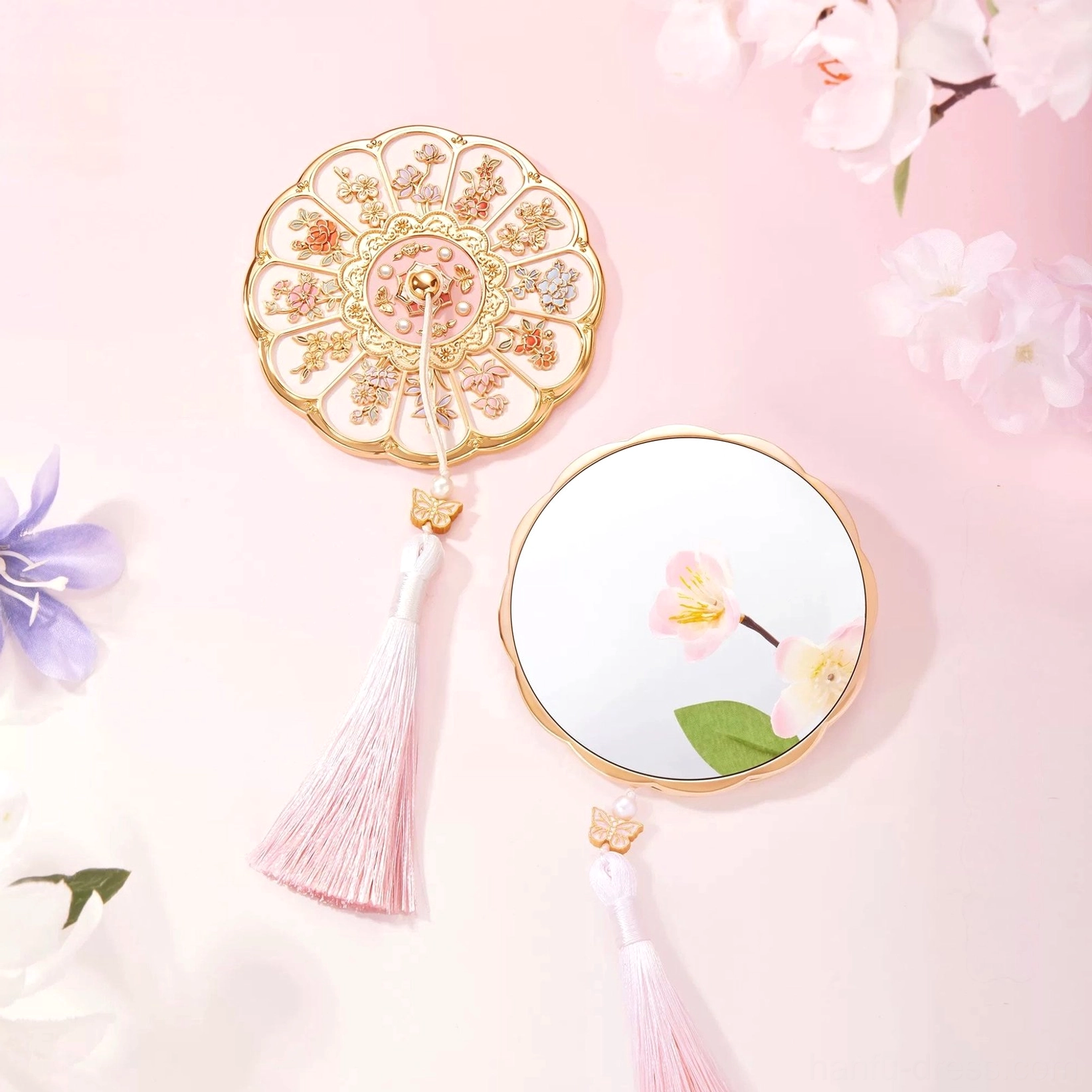 Twelve Flower Goddesses Chinese pocket mirror with petal-shaped floral cover, pink tassel, and pastel flower background