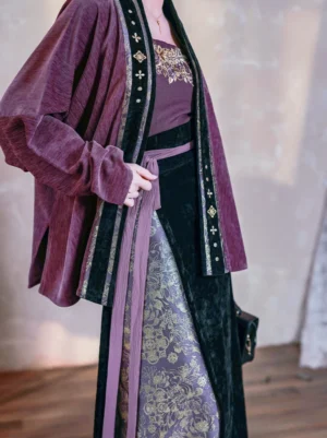 Close-up view of the Song Dynasty modern Hanfu jacket showing black collar trim, golden embroidered edging, purple waist sash, and patterned skirt details