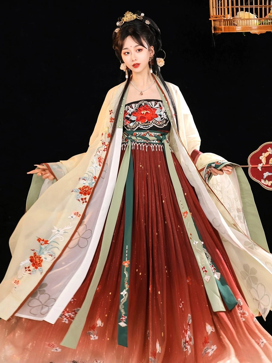 Side view of a model spreading the flowing Twilight Tang Dynasty Hanfu Heziqun skirt with green and ivory ribbon accents, floral embroidery, gradient hem, and round silk fan