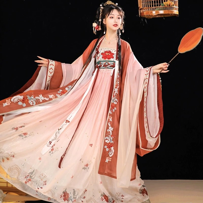 Full-length side view of the pink Twilight Tang Dynasty Hanfu Heziqun ensemble with embroidered chest panel, reddish-brown sleeve trim, floral gradient skirt, and round silk fan