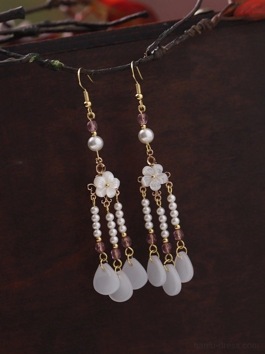 Two pairs of Chinese vintage flower tassel earrings displayed with white floral charms pearl accents purple beads and hanging pendants