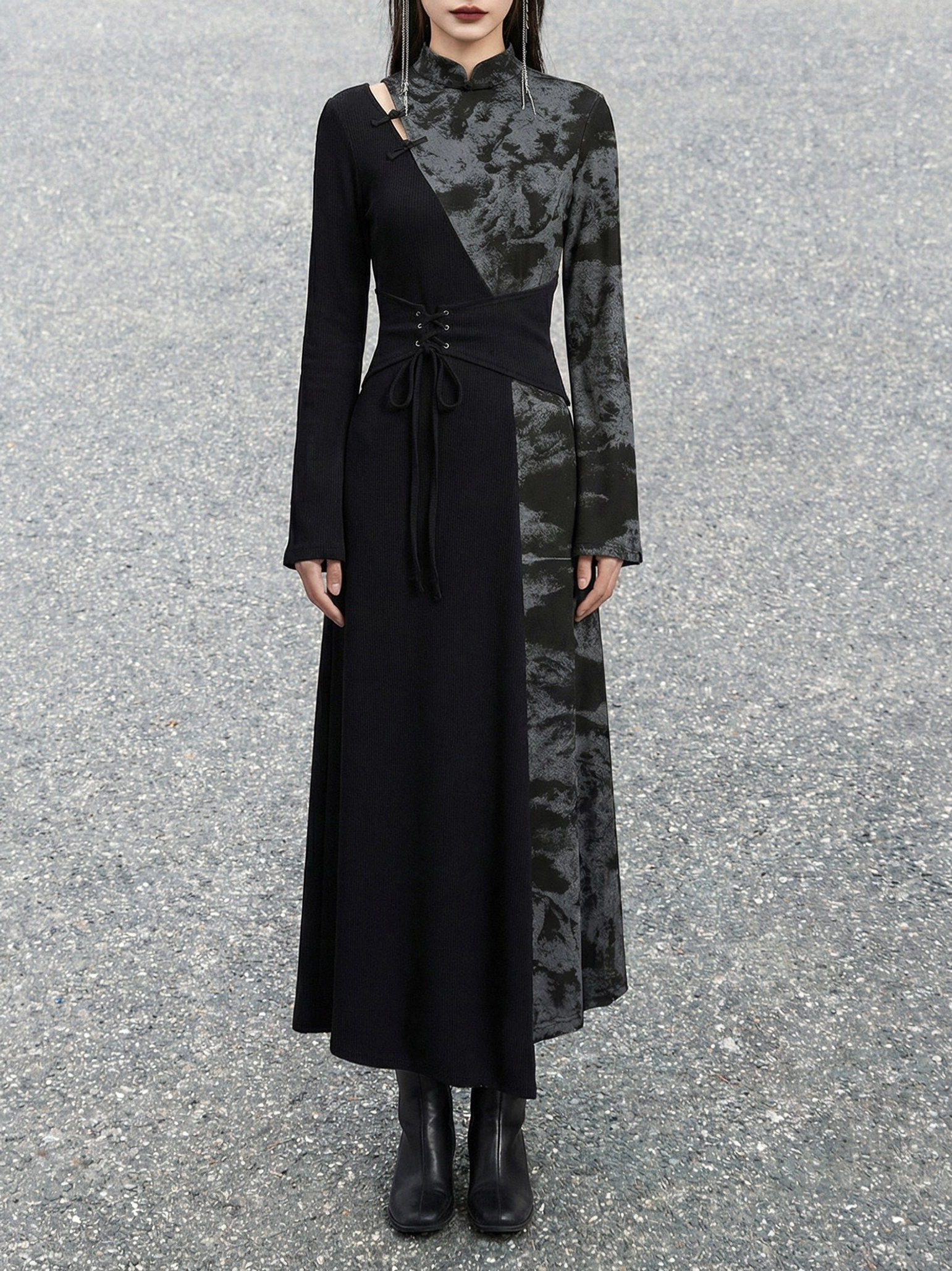 Front view of a two-tone black modern Hanfu dress featuring a stand collar, single shoulder cutout, patterned tie-dye panel, drawstring waist, and long sleeves