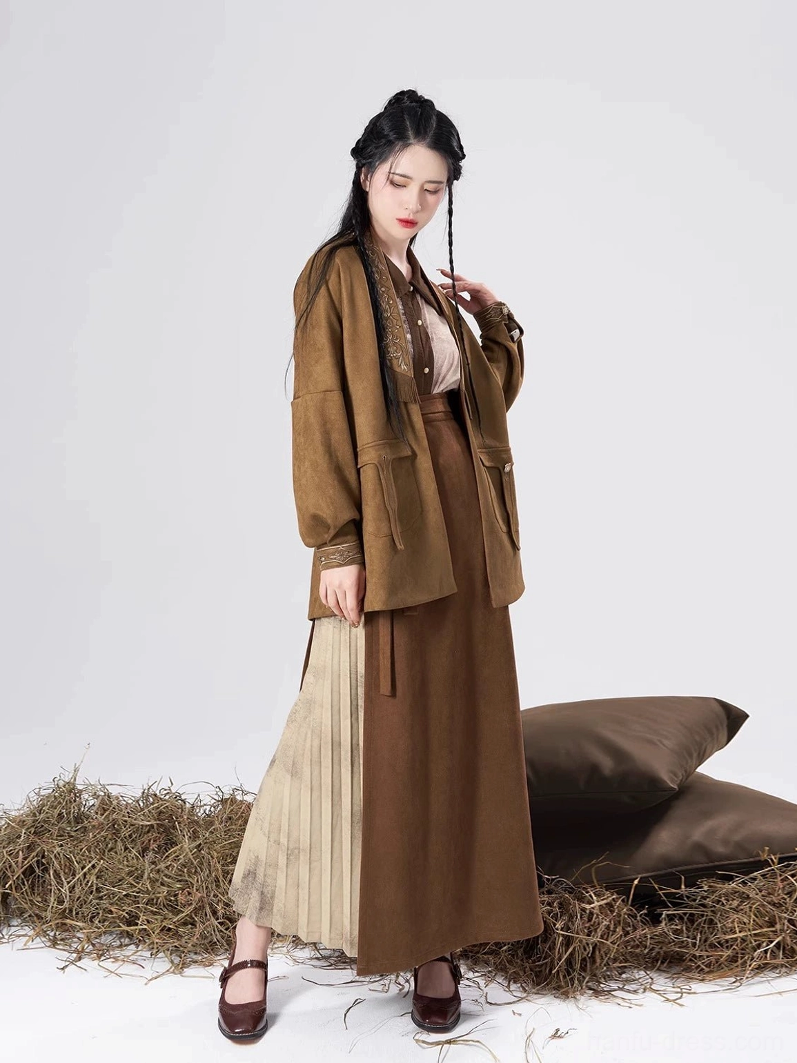 Two-tone modern Hanfu outfit showing a warm brown skirt with a contrasting beige pleated panel and relaxed open outer coat