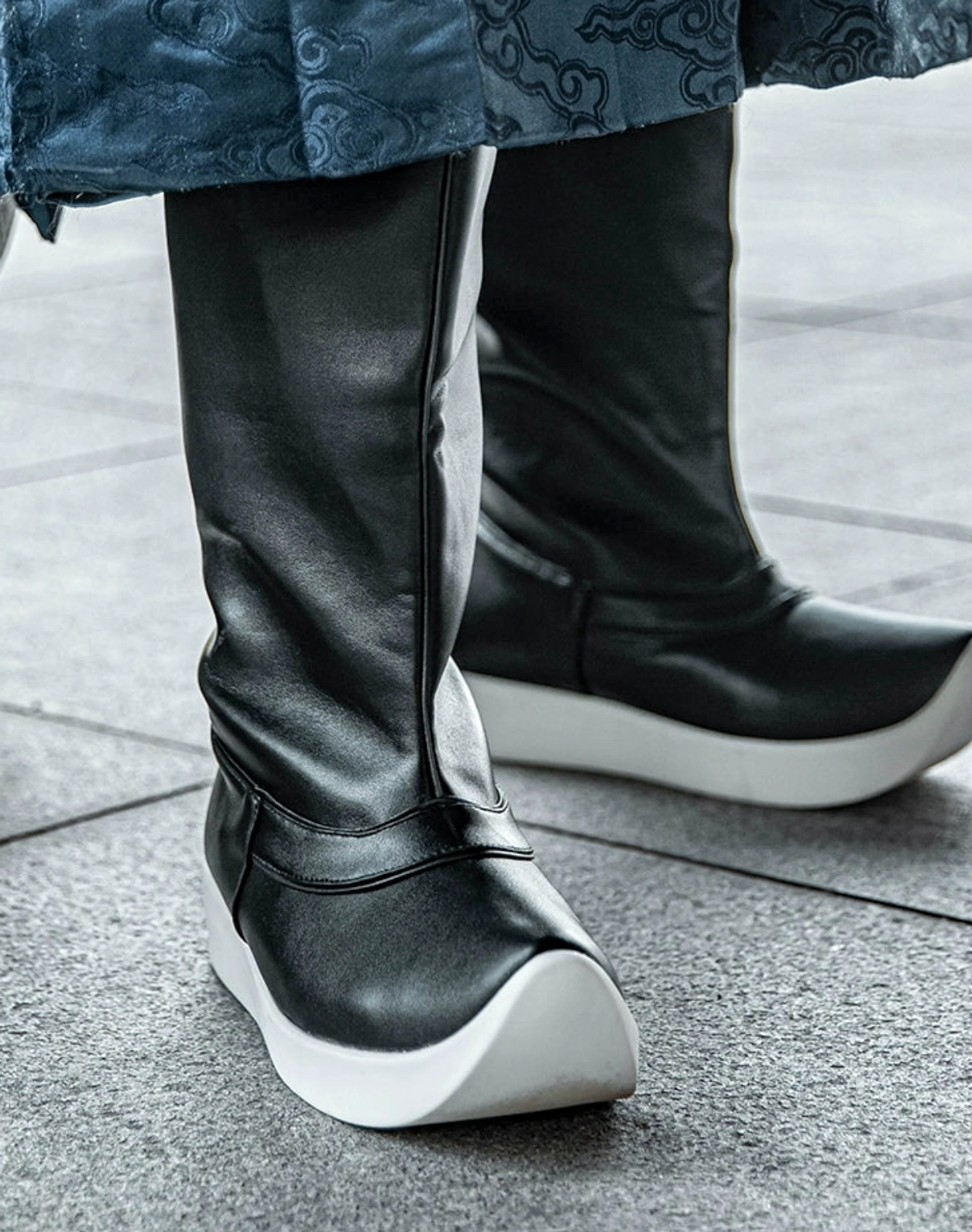 Side view of unisex black traditional Chinese Hanfu boots with mid-calf shaft, detailed stitching and contrasting white rubber platform sole