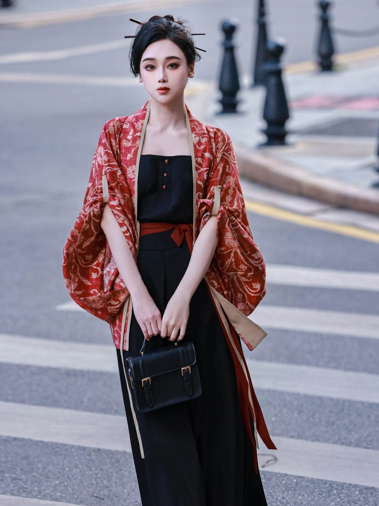 Front view of a Vermilion Bird modern Hanfu three-piece outfit with red waist bow loose cardigan sleeves black camisole and wide-leg pants