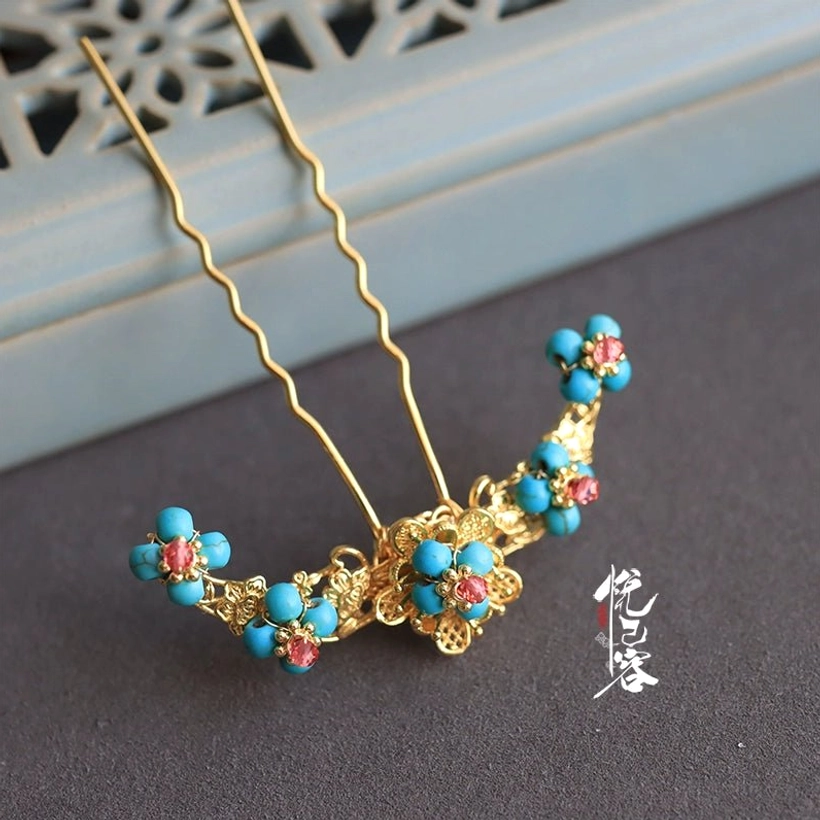 Side view of vintage Chinese floral U-shaped hair pin featuring gold-tone metal, blue round beads, and red flower decorations
