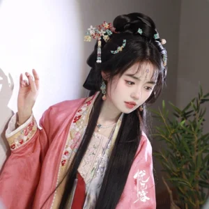 Model wearing a blue and red floral U-shaped hair pin with a pink Song style Hanfu hairstyle and traditional Chinese hair ornaments
