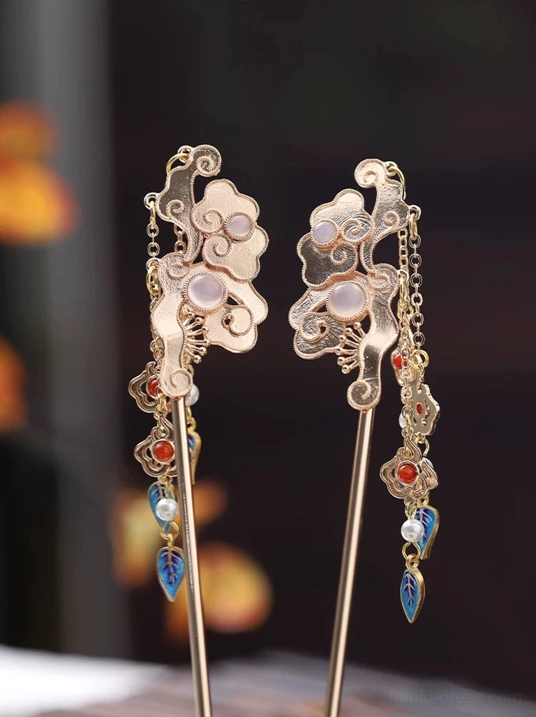 Pair of vintage Chinese cloud-themed hair sticks with gold-tone metal, pink gem accents, colorful tassels, red beads, pearls, and blue leaf pendants