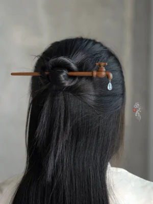 Vintage faucet wooden Chinese hair stick worn in a long half-up hairstyle with clear teardrop crystal pendant