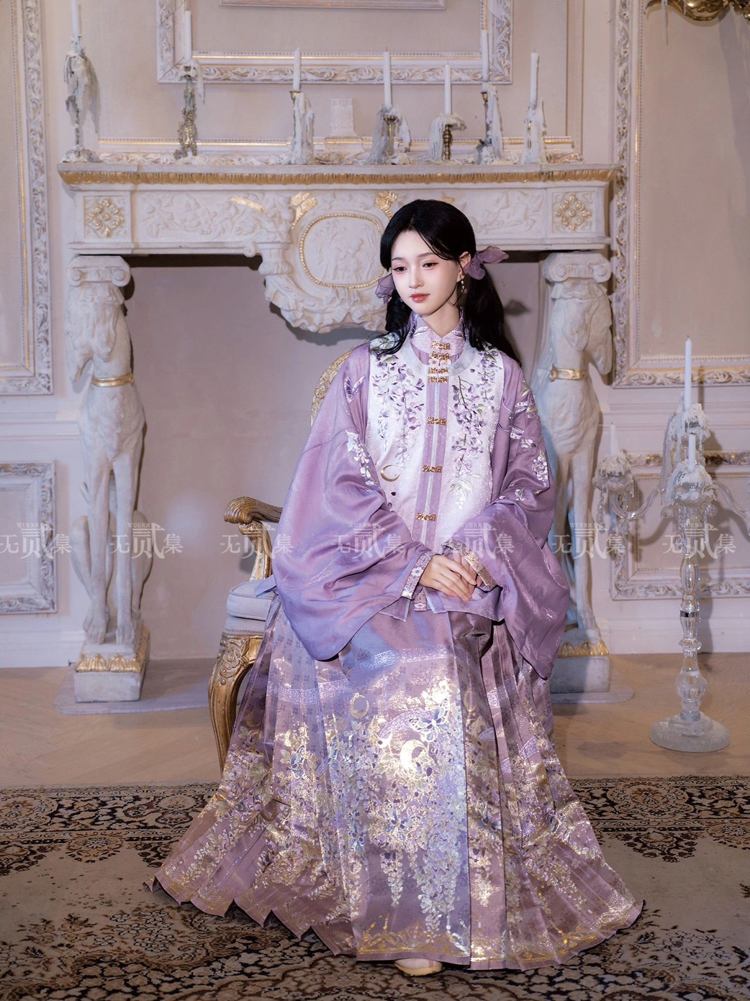 Seated three-quarter view of violet Ming Dynasty Hanfu showing embroidered floral Bijia vest and shimmering gold wisteria patterned Mamianqun skirt