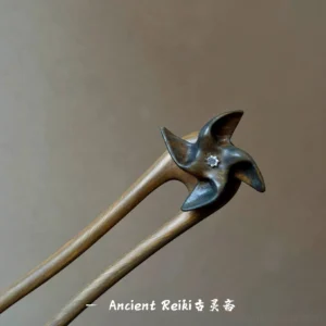 Waiting for Wind double-pronged wooden Hanfu hair stick displayed on a dark background, showing the windmill-shaped Chinese hair accessory with silver flower ornament and natural wood texture