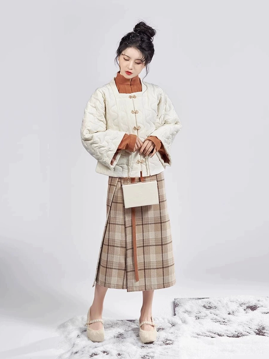 Front view of a warm neutral Ming Dynasty Hanfu outfit with cream padded jacket caramel top and side-split plaid mamianqun wrap skirt