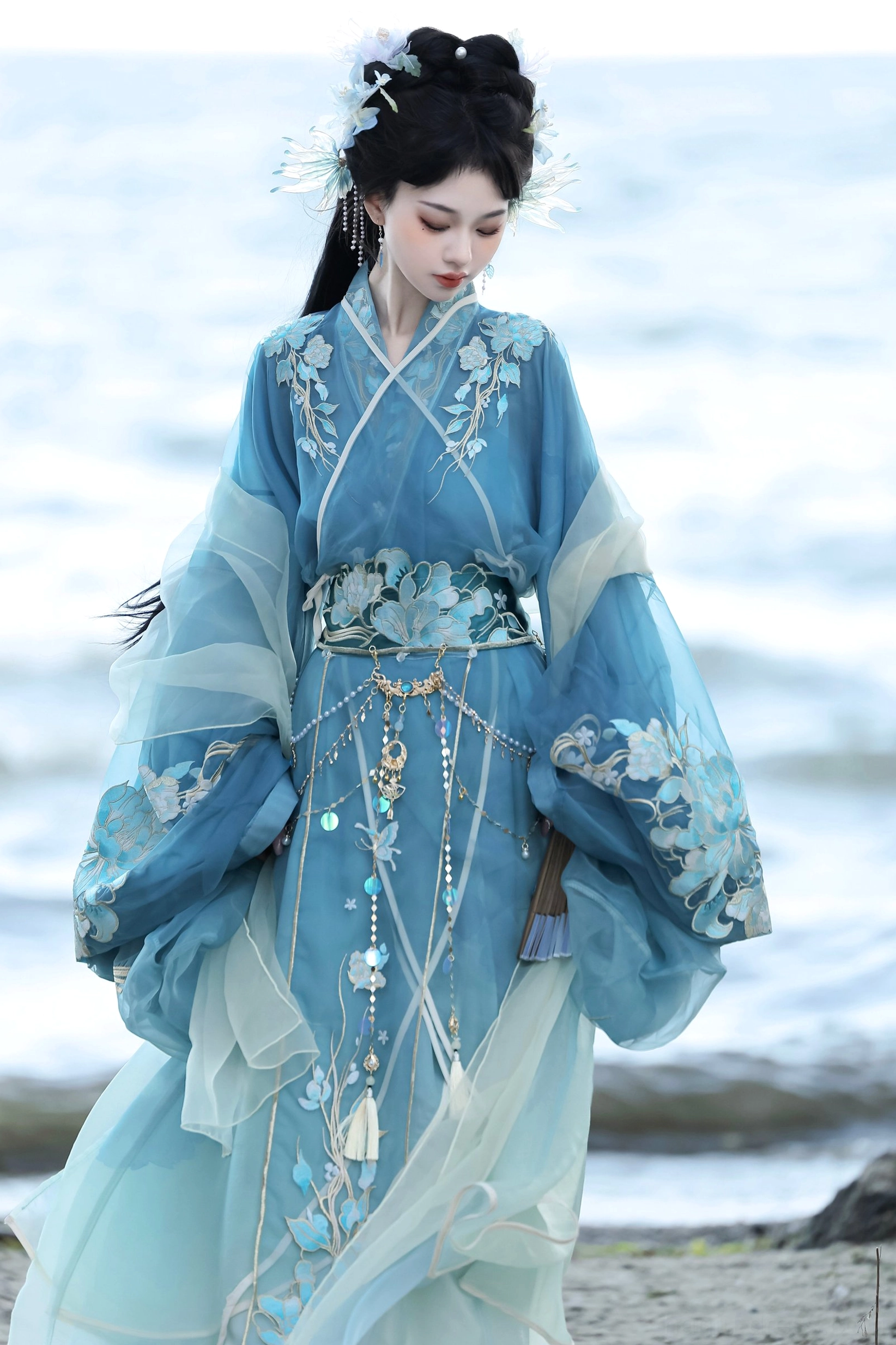 Warring States and Han Dynasty style blue Hanfu complete set shown in a lakeside portrait with floral embroidery, sheer organza layers, and ornate tassel waist chain