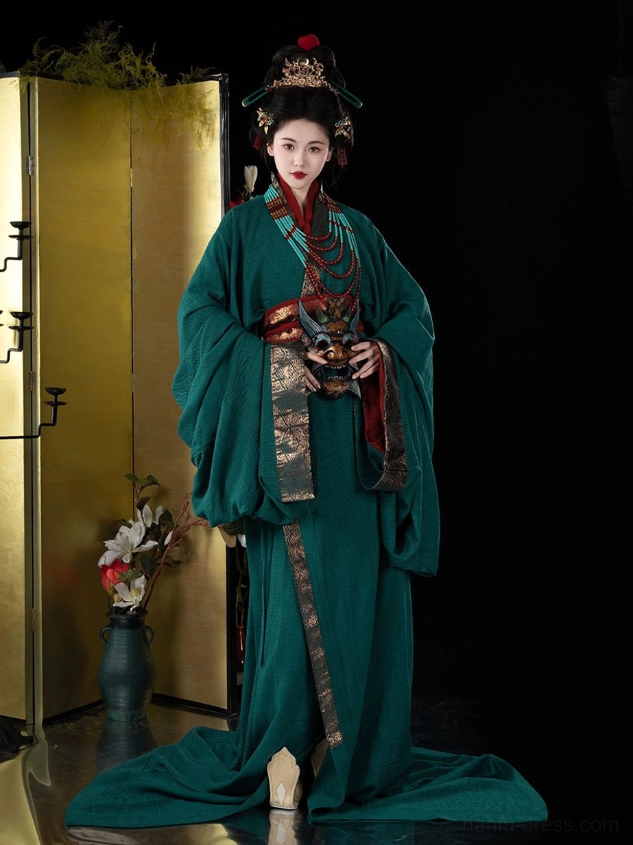 Front three-quarter view of emerald green Han Dynasty Hanfu straight hem robe with gold edging, red sash, layered ornaments, and flowing train