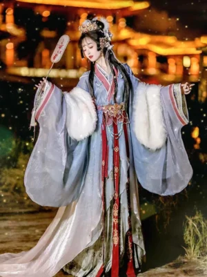 Blue and lavender gradient Warring States Han Dynasty Hanfu straight-hem robe with wide faux-fur sleeves, red trim, golden waist ornament, and flowing skirt worn in a lantern-lit ancient Chinese setting