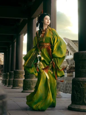 Olive green Warring States and Han Dynasty Hanfu straight hem robe shown in a palace colonnade with gold embroidered trim, red waist sash, wide sleeves, and flowing trailing ribbons