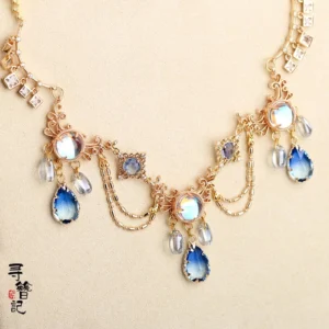 Close-up of Water Fairy Chinese Hanfu necklace with blue teardrop pendants floral metal charms pearl beads and chain tassels