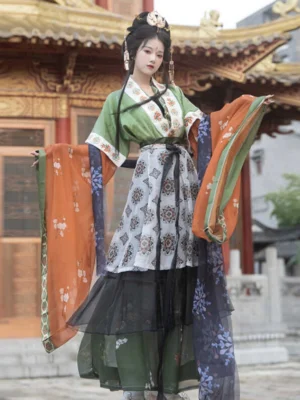 Full-body front view of a Wei Jin Dynasty Butterfly Scroll Qiyao Ruqun Hanfu with green cross-collar top, patterned high-waisted skirt, wide contrasting sleeves and layered sheer hems in an ancient Chinese imperial courtyard