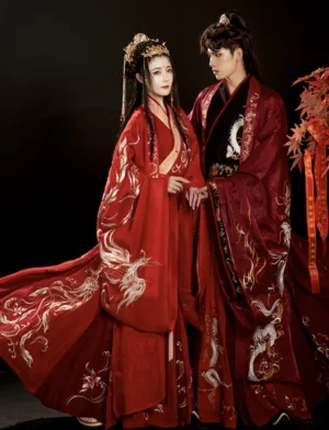 Wei Jin Dynasty Chinese wedding hanfu set with red phoenix embroidered bridal gown and dark maroon dragon robe displayed as a traditional wedding couple ensemble