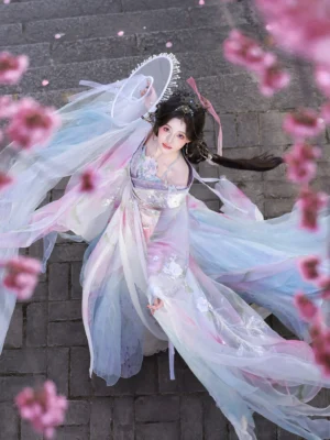 Dynamic low-angle view of a Wei Jin Dynasty fairy Hanfu with embroidered halter top, layered sheer robes, flowing train and round Chinese fan among cherry blossoms