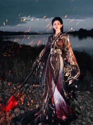 Full-body view of a General Mulan inspired Wei Jin Dynasty embroidered Hanfu robe in black, gold, red, and white with wide cross-collar sleeves and a flowing gradient skirt beside a riverside at night