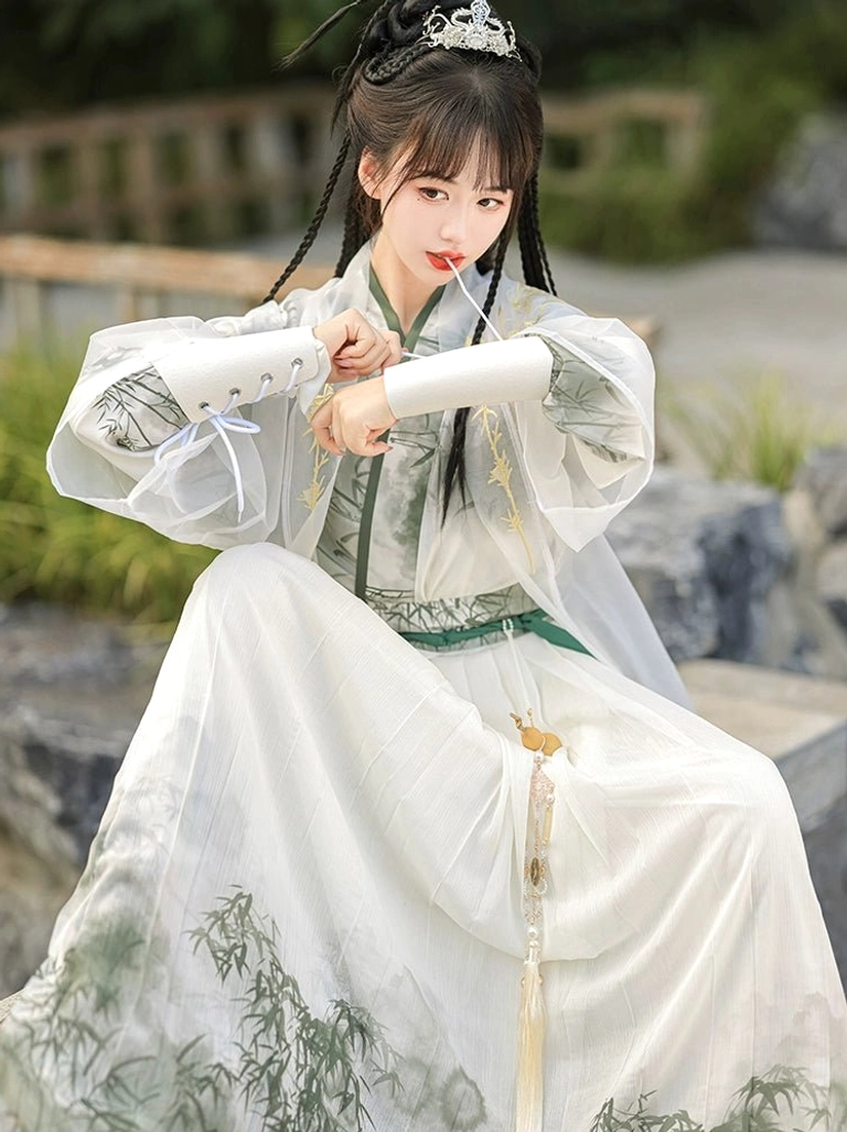 Wei Jin Dynasty Hanfu close-up showing green trimmed cross-collar top lace-up white arm bracers and bamboo skirt