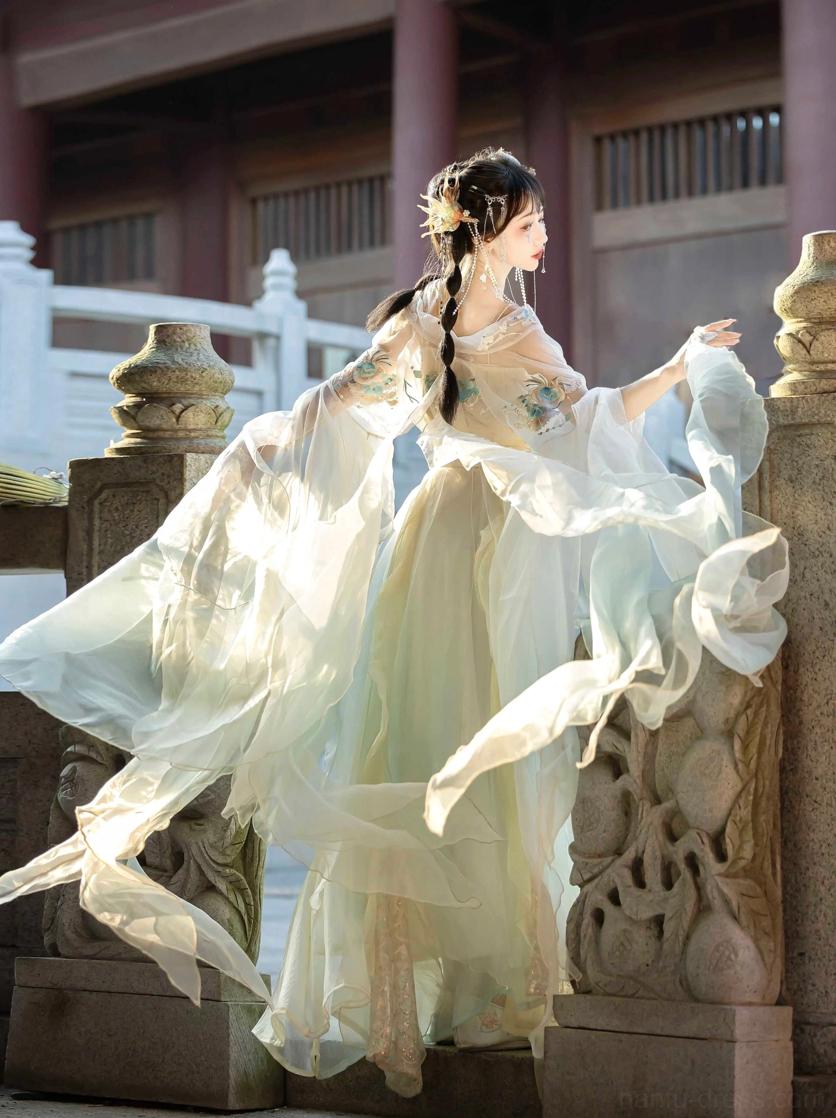 Yellow green Wei Jin Dynasty Hanfu side three quarter view showing embroidered off shoulder bodice flowing translucent sleeves matching waist sashes and layered tulle skirt