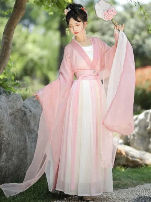 Wei Jin Dynasty Hanfu side view showing the elegant flowing sleeves, soft pink and ivory gradient fabric, high waist sash, and graceful wrap skirt