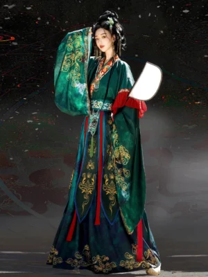 Wei Jin Dynasty Nuo opera style Hanfu set in emerald green shown in a full body three quarter side view with wide embroidered sleeves and red cuff layers